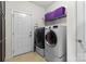 Bright laundry room featuring a modern washer and dryer, with easy access to an exterior door at 2010 Brightflower Ln, York, SC 29745