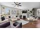 Bright living room with hardwood floors, a ceiling fan, a fireplace, and lots of plants at 2010 Brightflower Ln, York, SC 29745