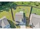Aerial view of a fenced backyard with a patio, playset, trampoline and fire pit on a well-manicured lawn at 210 Clove Hitch Dr, Statesville, NC 28677