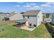 An outdoor space with a covered patio with comfortable seating, a dining area, and grilling station at 210 Clove Hitch Dr, Statesville, NC 28677