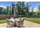Large, grassy backyard with a dining table and patio set for entertaining guests at 210 Clove Hitch Dr, Statesville, NC 28677