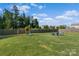 Expansive backyard including a swing set, slide, and outdoor seating area at 210 Clove Hitch Dr, Statesville, NC 28677
