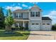 Charming two-story home featuring gray siding, a two-car garage, and a well-manicured lawn at 210 Clove Hitch Dr, Statesville, NC 28677
