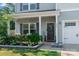 Inviting front porch with decorative wreath, seating area, and manicured landscaping for curb appeal at 210 Clove Hitch Dr, Statesville, NC 28677