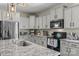 Well-equipped kitchen with stainless steel appliances, granite countertops, and ample cabinet space at 210 Clove Hitch Dr, Statesville, NC 28677