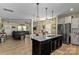 Modern kitchen with stainless steel appliances and island opens to living room at 210 Clove Hitch Dr, Statesville, NC 28677