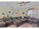 Cozy living room with a large sectional sofa, decorative wall art, and a view of the front entrance at 210 Clove Hitch Dr, Statesville, NC 28677