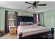 Spacious main bedroom with neutral tones, a ceiling fan, and large windows at 210 Clove Hitch Dr, Statesville, NC 28677