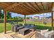 Relaxing covered patio featuring outdoor furniture, string lights and a lush lawn at 210 Clove Hitch Dr, Statesville, NC 28677