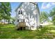 Exterior view of the home's backyard and deck with green grass at 2732 Mayfair Ave, Charlotte, NC 28208