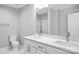 Modern bathroom featuring double sinks, white cabinets, and a glass-enclosed shower at 2732 Mayfair Ave, Charlotte, NC 28208