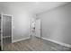 Clean bedroom with neutral walls and light vinyl floors leads to a closet at 2732 Mayfair Ave, Charlotte, NC 28208