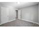 Bedroom with neutral paint and carpet, featuring two doors at 2732 Mayfair Ave, Charlotte, NC 28208