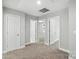 A bright bedroom with neutral walls and carpet features three doors and an overhead light at 2732 Mayfair Ave, Charlotte, NC 28208