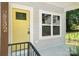 Inviting front entrance with a bright yellow door and large windows, complemented by fresh gray siding at 2732 Mayfair Ave, Charlotte, NC 28208