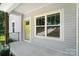 Covered porch featuring a yellow front door and large windows that provide plenty of natural light at 2732 Mayfair Ave, Charlotte, NC 28208