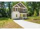 Well-manicured front yard showcases this two-story home's clean lines and newly poured concrete driveway at 2732 Mayfair Ave, Charlotte, NC 28208