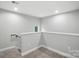 Bright upstairs hallway, neutral paint, carpeted, and window at 2732 Mayfair Ave, Charlotte, NC 28208