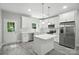 Bright kitchen boasts an island, stainless steel appliances, white cabinets, and sleek countertops at 2732 Mayfair Ave, Charlotte, NC 28208