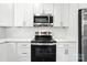 Kitchen showcases stainless steel appliances, white cabinetry, and a white subway tile backsplash at 2732 Mayfair Ave, Charlotte, NC 28208