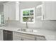 Close-up of a kitchen sink and subway tile backsplash, illuminated by natural light from the window at 2732 Mayfair Ave, Charlotte, NC 28208