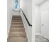 Carpeted staircase with a black railing leads to the upper level at 2732 Mayfair Ave, Charlotte, NC 28208
