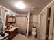 Modest bathroom featuring a sink, toilet, shower, and tiled walls at 302 Margarette Ave, Belmont, NC 28012