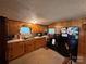 Functional kitchen with wood cabinets, a standard black refrigerator, and essential appliances at 302 Margarette Ave, Belmont, NC 28012