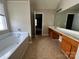 Bright bathroom with soaking tub and double sink vanity at 3022 Hendricks Chapel Ln, Charlotte, NC 28216