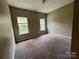 Neutral bedroom featuring carpeted floors, two windows and neutral walls at 3022 Hendricks Chapel Ln, Charlotte, NC 28216