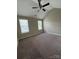 Spacious bedroom featuring a vaulted ceiling, carpeted floor, and large windows for plenty of natural light at 3022 Hendricks Chapel Ln, Charlotte, NC 28216
