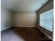 Cozy bedroom with neutral walls, carpet, and natural light from the window at 3022 Hendricks Chapel Ln, Charlotte, NC 28216