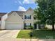 Charming two-story home with a two car garage and manicured lawn at 3022 Hendricks Chapel Ln, Charlotte, NC 28216