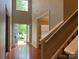Open foyer with hardwood floors, staircase, and view of the front yard at 3022 Hendricks Chapel Ln, Charlotte, NC 28216