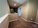 Second floor hallway with carpeted flooring and two doors at 3022 Hendricks Chapel Ln, Charlotte, NC 28216