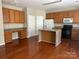 Eat-in kitchen with oak cabinets, granite countertops, and a center island at 3022 Hendricks Chapel Ln, Charlotte, NC 28216