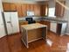 Functional kitchen features a center island, wood cabinets, and modern appliances at 3022 Hendricks Chapel Ln, Charlotte, NC 28216