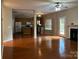 Open living room with fireplace, hardwood floors, and access to the backyard at 3022 Hendricks Chapel Ln, Charlotte, NC 28216