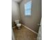 Small powder room with tile floor and window at 3022 Hendricks Chapel Ln, Charlotte, NC 28216
