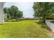 Large grassy backyard featuring mature trees and a white picket fence at 3702 Arthur St, Indian Trail, NC 28079