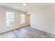A serene bedroom with neutral tones, two bright windows, and new gray flooring at 3702 Arthur St, Indian Trail, NC 28079