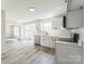 Bright kitchen with modern appliances, white cabinets, and gray floors that give an airy, spacious feel at 3702 Arthur St, Indian Trail, NC 28079