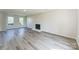 Bright living room featuring modern fireplace, grey floors and two large windows providing natural light at 3702 Arthur St, Indian Trail, NC 28079