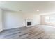 Bright living room featuring modern fireplace, grey floors and a large window providing natural light at 3702 Arthur St, Indian Trail, NC 28079