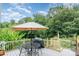 Back deck featuring outdoor seating, lush landscaping, and overhead shade at 4124 Oakwood Rd, Charlotte, NC 28269
