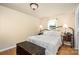 Cozy bedroom featuring hardwood floors, a metal bed frame, and bright natural lighting at 4124 Oakwood Rd, Charlotte, NC 28269