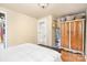 Bedroom featuring hardwood floors, bright natural lighting, a metal bed frame, and antique dresser at 4124 Oakwood Rd, Charlotte, NC 28269