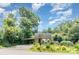 Inviting home with colorful flower garden, carport, and ample greenery providing a private setting at 4124 Oakwood Rd, Charlotte, NC 28269