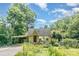 Charming home featuring lush landscaping, a covered carport, and inviting curb appeal on a sunny day at 4124 Oakwood Rd, Charlotte, NC 28269