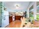 Charming kitchen featuring colorful tile backsplash, wooden cabinets, and ample natural light at 4124 Oakwood Rd, Charlotte, NC 28269